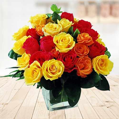 Yellow and Cheery mixed Roses in a Glass vase
